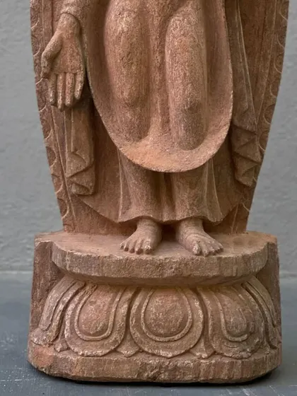 A detail shot showing the base of our Pala dynasty style standing Buddha, focusing on the delicate carving of the feet and lotus pedestal.