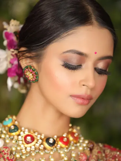 A close-up shot showcasing soft, shimmery eyeshadow and flawless skin. The focus on the eyes and jewelry makes it ideal for both makeup and accessory brands.
