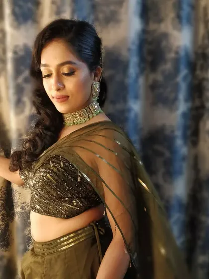 A candid moment from the engagement party. The bride's makeup is flawless, with a focus on radiant skin and defined eyes that sparkle in the evening light.