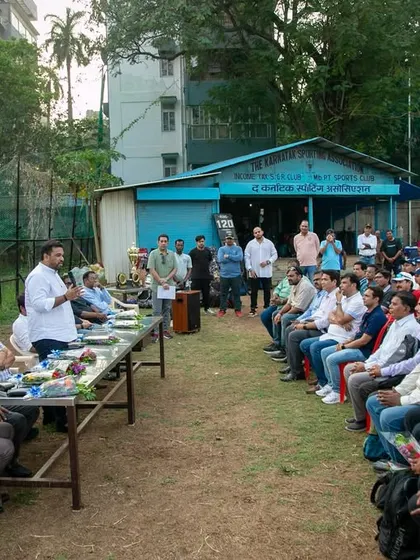 An overview of the audience, including players, parents, and coaches, listening intently during the prize distribution ceremony of the U-16 Payyade Trophy at Karnatak Sporting Association.