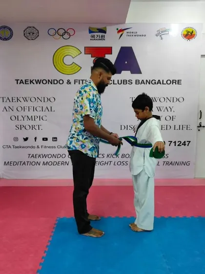 Tying a green belt.