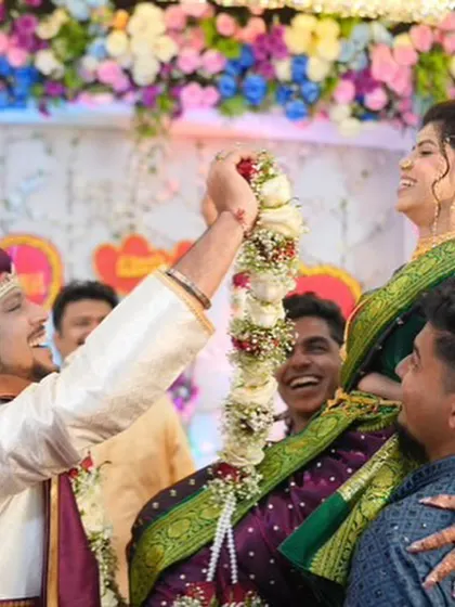 A fun and joyous moment from the varmala ceremony. The bride's makeup remains perfect even during playful moments.