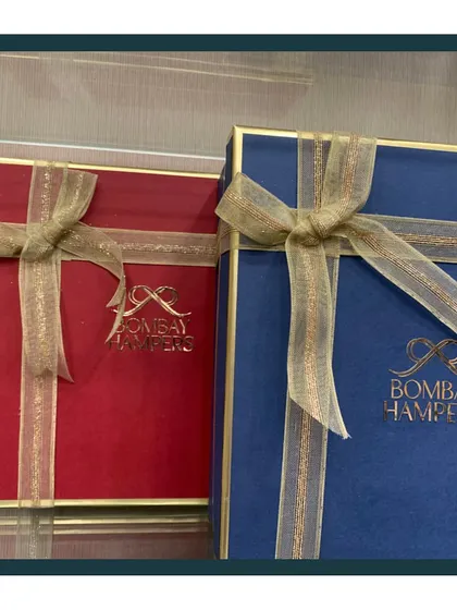 My signature gift boxes are a statement of quality and elegance. The gold foil logo on the rich red and blue boxes ensures your gift looks premium from the very first glance.