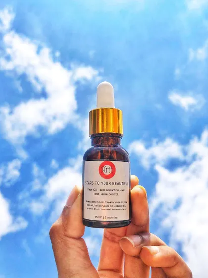 A bottle of my 'Scars to Your Beautiful' face oil, a blend of natural oils designed to heal and beautify your skin. It's suitable for all genders and skin types.