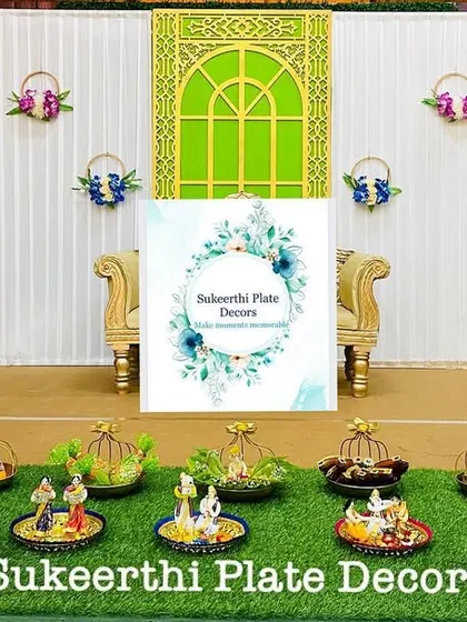 For this engagement at Natraj Mahal, I created a setup with hanging basket props and thematic dolls. The 'uppu kudai' (salt basket) is a traditional element I often include.