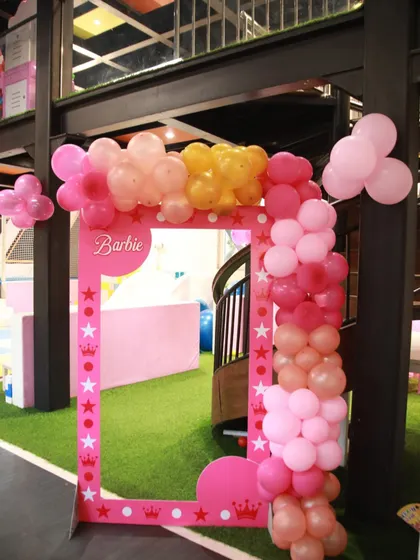 A fun, life-sized Barbie photo frame for guests to pose in. The pink frame with stars and crowns is always a popular spot for pictures.