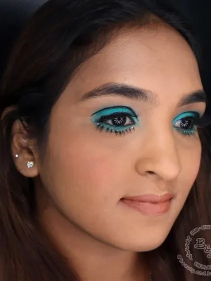 This angle highlights the complete eye makeup, including the voluminous false lashes on the top lash line. Paired with a soft, neutral lip, the focus remains entirely on the dramatic, retro eyes.