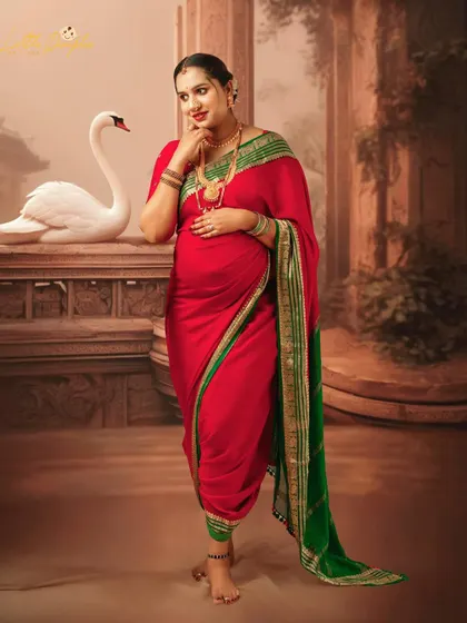 A playful and elegant pose in a traditionally draped red saree. The swan in the background adds a touch of grace and beauty to this fine art portrait.