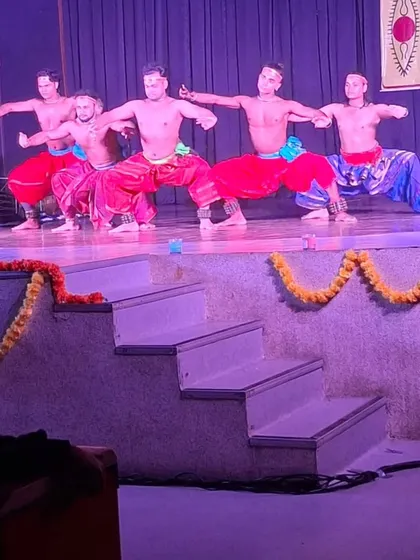 My troupe performing a synchronized sequence at a SPIC MACAY event. The low stage brings the powerful movements of Chhau closer to the audience.