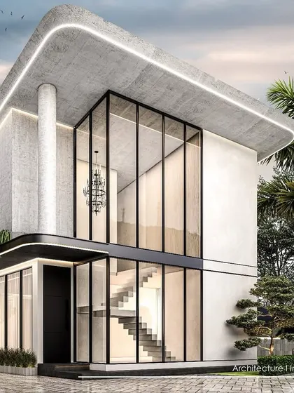 A close-up view of the Goa villa concept, detailing the double-height glass entryway and the smooth, rounded edges of the concrete structure.