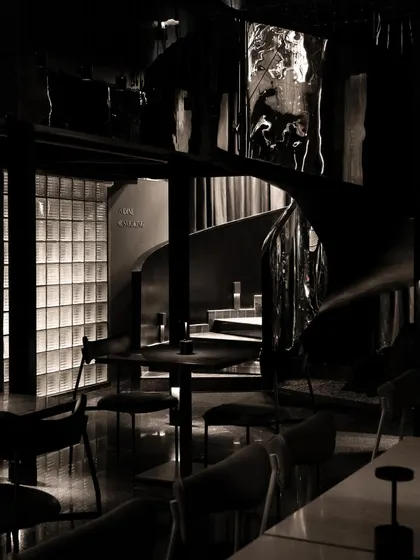 A collection of atmospheric shots from Lair, showcasing the interplay of black concrete, glass blocks, polished steel, and dramatic lighting. Each image captures a fragment of the bar's mysterious and immersive character.