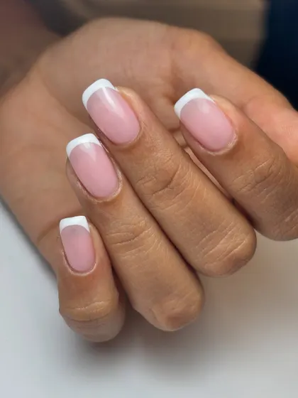 A perfect, classic French manicure. The lines are crisp, the base is a natural sheer pink, and the result is effortlessly elegant.