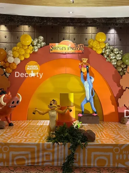 A straight-on shot of the Lion King stage, showcasing the symmetry and vibrant colors of the Pride Rock backdrop.