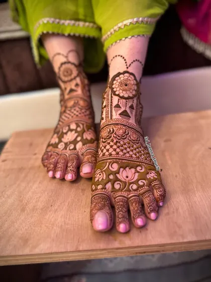 A beautiful bridal foot design featuring lotus flowers and other traditional motifs. The pattern extends from the ankle to the toes for a complete look.