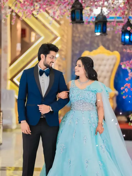 A classic portrait of Shraddha and Vivek at their engagement reception. This shot captures the couple looking elegant against the backdrop of their grand celebration.
