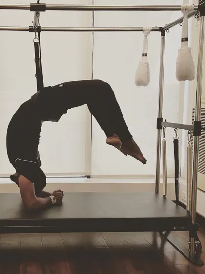 Striving for your best is what matters. This inverted pose on the Cadillac challenges balance, core strength, and mental focus.