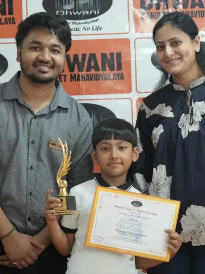 A young winner with his teacher and parent. This picture captures the triangle of support that is essential for a child's success in the arts.