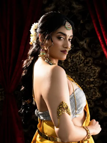 A beautiful over-the-shoulder pose that highlights the earrings and the hairstyle, showing how the jewellery completes the entire bridal look.
