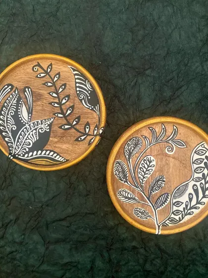 The botanical plates photographed against a dark green background, creating a moody and sophisticated look.