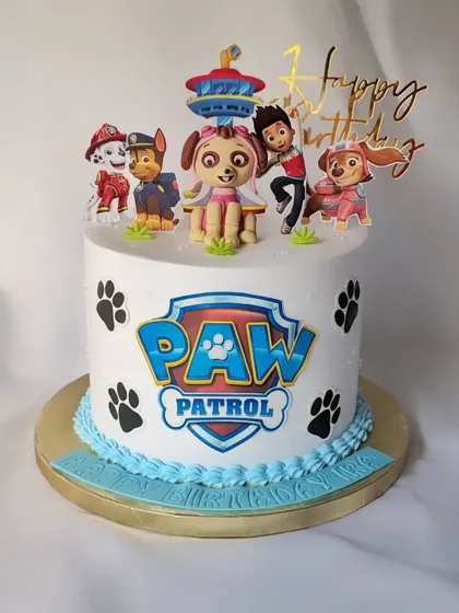 This Paw Patrol cake is ready for a ruff-ruff rescue! It's a non-fondant cake decorated with the Paw Patrol logo, paw prints, and all the main characters, including a fondant Skye topper.