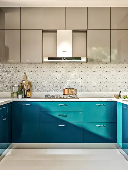 I love using color to create unique and stylish kitchens. This U-shaped layout combines bold, high-gloss teal lower cabinets with neutral grey upper units and a striking geometric backsplash, proving that functional design can also be full of personality.