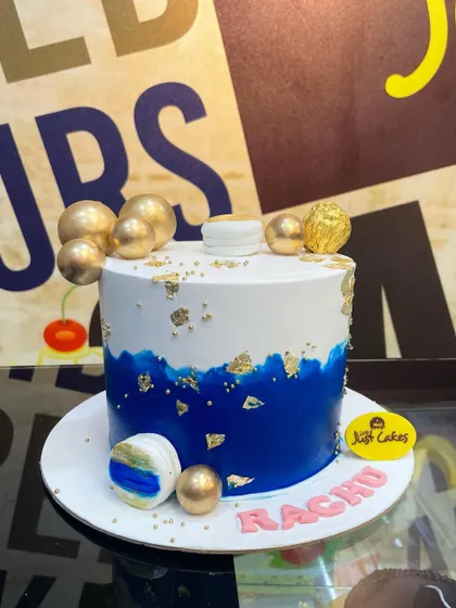 A stylish 1.5kg cake with a blue brushstroke effect, gold leaf, and golden spheres.