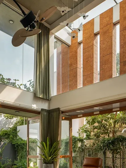 A view looking up at the laterite stone fins and large windows, as seen in a media feature.