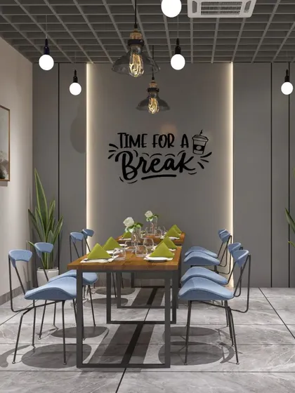 A break area in an office with the words "Time for a Break" on the wall. The industrial-style table and chairs create a casual and inviting atmosphere.
