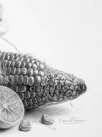 A close-up of the corn and lemon, highlighting the texture of the kernels and the citrus peel.