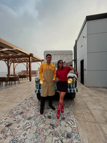 With the chef in front of a quirky food truck at the Oman resort, showcasing the unique and fun environments I get to play in.