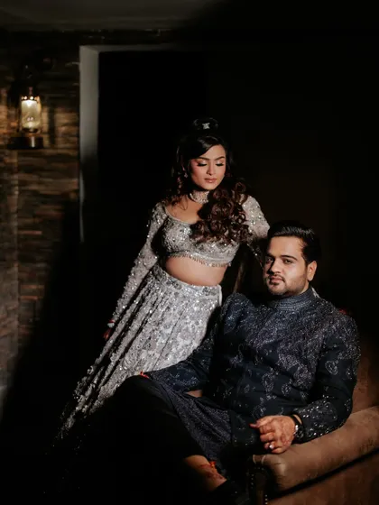A classic, posed portrait of the couple on their Sangeet night, showcasing their intricate outfits and the sophisticated mood of the evening.