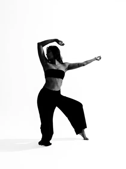 A classic dance pose captured in a minimalist black and white style.