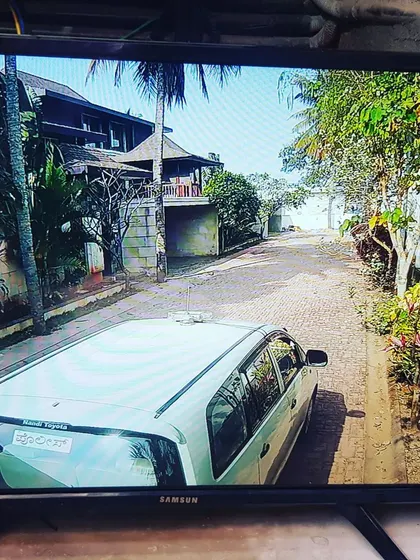 A view of the driveway showing a car, demonstrating the clarity of the CP Plus IP camera system.