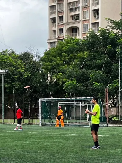 A coach observes players during a practice match, ready to provide instant feedback. Our experienced coaches are always on hand to guide players on positioning, strategy, and technique.