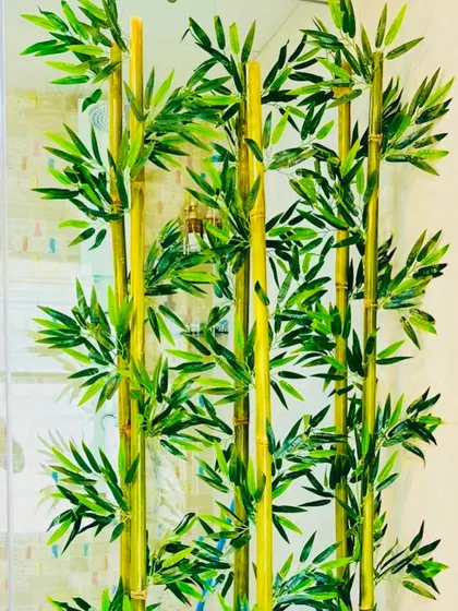 A close-up view of the artificial bamboo stalks. You can see the detail in the nodes and leaves, which makes them nearly indistinguishable from real bamboo plants.