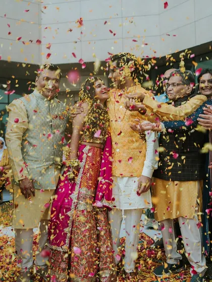 A moment of pure bliss as the couple is showered with flower petals by their families during the Haldi ceremony.