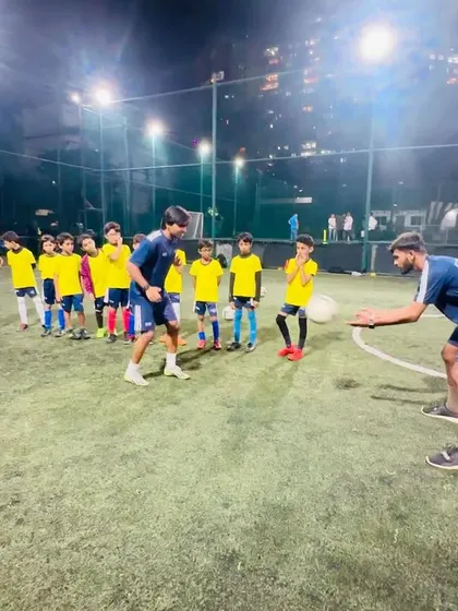 Two coaches demonstrate a heading drill for the U9 team. We teach proper and safe techniques for all aspects of the game.
