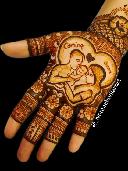 A single-hand design featuring a beautiful portrait of the expecting family within a heart, captioned "Coming Soon". This is a great option for a more focused yet meaningful baby shower henna.