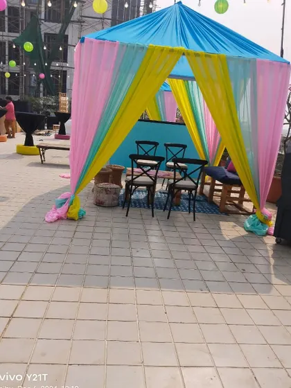 A vibrant cabana with seating, perfect for creating smaller, intimate zones within a larger wedding event on a terrace.