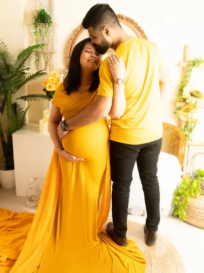 A tender moment with a kiss on the forehead. The matching yellow outfits create a bright and joyful theme for this couple's shoot.