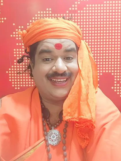 Another happy picture in my swamiji character getup. The orange turban and rudraksha beads are key parts of this look.