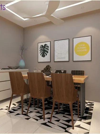 The dining area in 'Konark Splendor'. The design is clean and simple, with wooden chairs, a geometric rug, and minimalist art prints creating a stylish and uncluttered space.