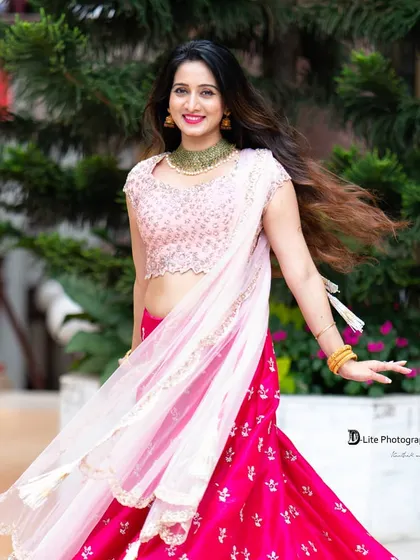 A beautiful shot of Harshika Poonacha with her dupatta flowing. This captures a sense of grace and movement, perfect for ethnic wear catalogues.