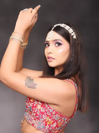 Creativity comes from loving your work. This modern makeup look features a dramatic, colorful smokey eye, paired with a traditional matha patti for a fusion style.
