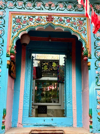 A beautifully preserved haveli doorway in Old Delhi, painted in vibrant shades of blue and pink. This is the kind of hidden architectural gem we love to show our guests on our 'Vanishing Havelis' walk.