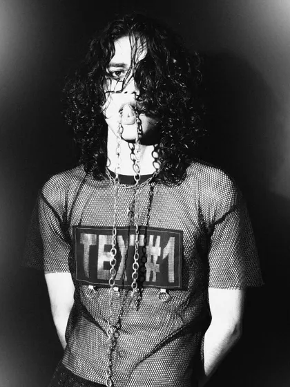 A moody and mysterious portrait. The use of chains and messy hair in this black and white shot builds a strong, alternative character.