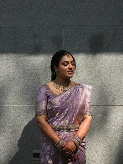 An artistic shot using shadows and light. The bride's features are beautifully highlighted, showing the flawless finish of her makeup.