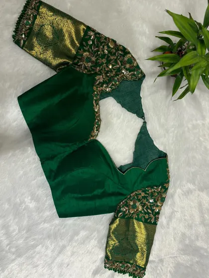 The finished bottle green bridal blouse, featuring heavy sequin and thread work on the sleeves and a unique neckline.