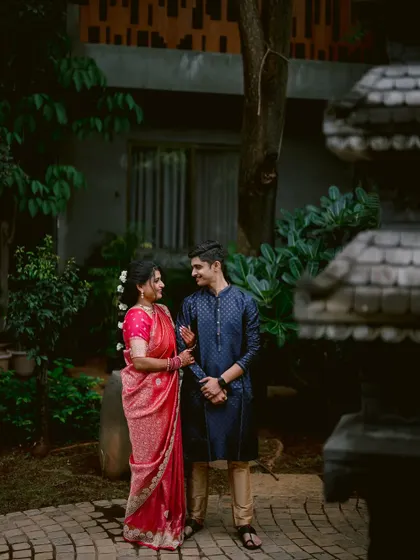 A candid moment of conversation between Apeksha and Rutwij in a garden setting.