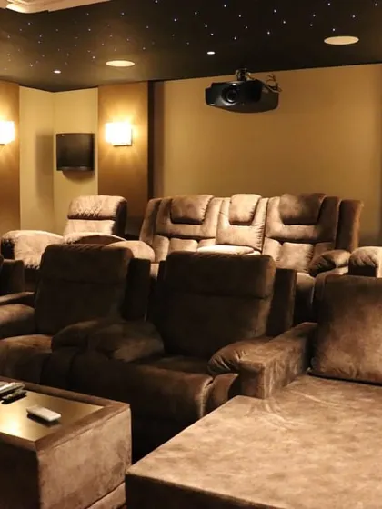 The full seating arrangement in this Salem project, with multiple rows of plush recliners and lounges, all oriented towards the screen for a perfect viewing experience.